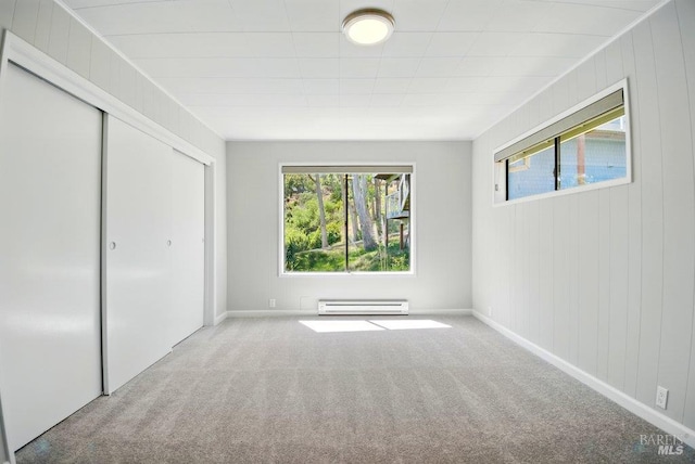1685 Bay Flat Rd, Bodega Bay, CA 94923 - unfurnished bedroom with baseboard heating, multiple windows, and carpet