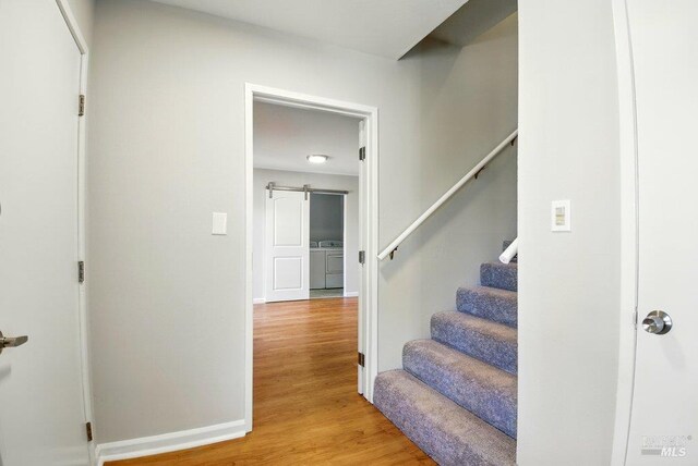 1685 Bay Flat Rd, Bodega Bay, CA 94923 - stairway featuring wood finished floors, washer / clothes dryer, and baseboards