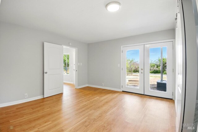 1685 Bay Flat Rd, Bodega Bay, CA 94923 - unfurnished room with light wood-type flooring, baseboards, and french doors