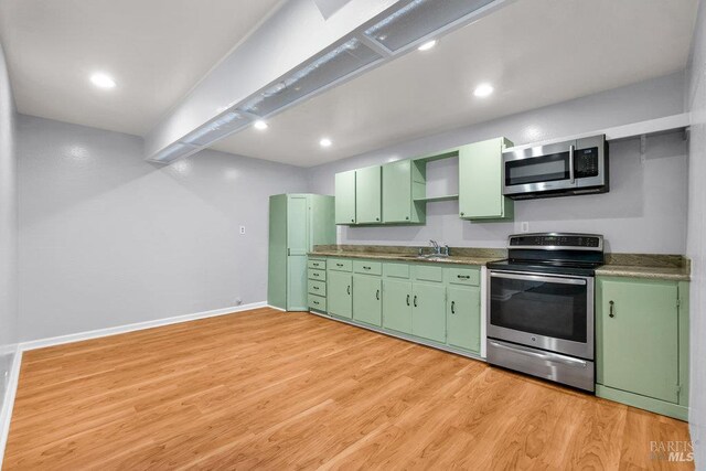 1685 Bay Flat Rd, Bodega Bay, CA 94923 - kitchen with stainless steel appliances, green cabinets, light wood-style flooring, baseboards, and recessed lighting