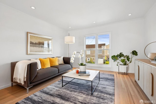 living area featuring recessed lighting, light wood-style flooring, baseboards, and ornamental molding