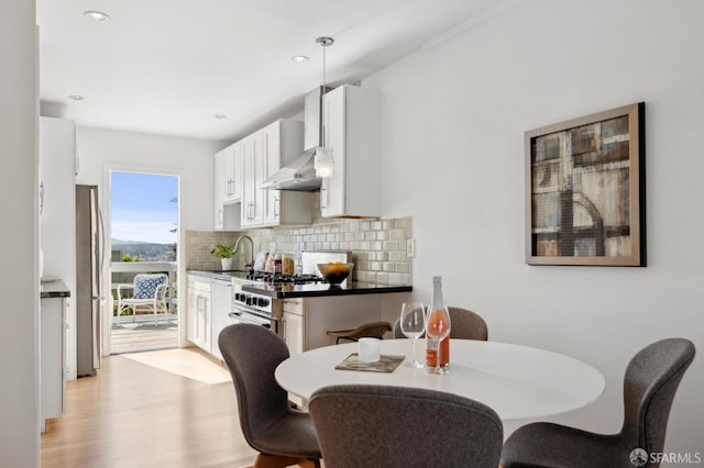 dining space featuring recessed lighting and light wood-style floors