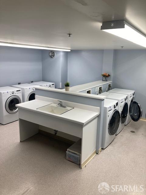 240 Lombard St Unit 329, San Francisco, CA 94111 - shared laundry room with washing machine and dryer and light carpet