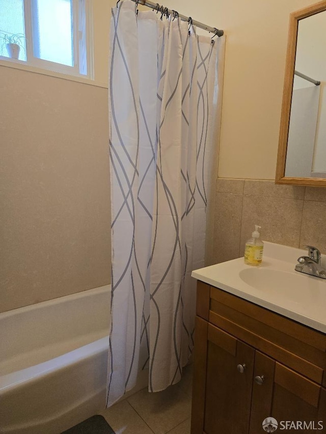 bathroom featuring tile patterned flooring, shower / tub combo with curtain, and vanity