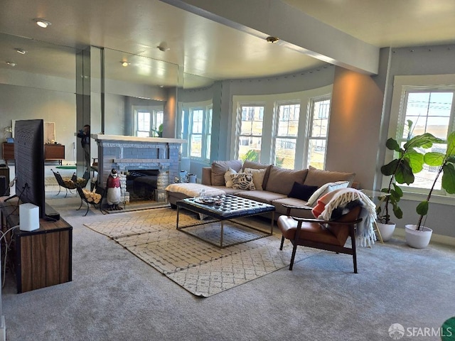 carpeted living area featuring a brick fireplace
