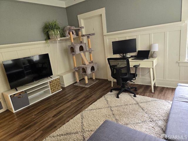 office area featuring wainscoting, wood finished floors, and a decorative wall