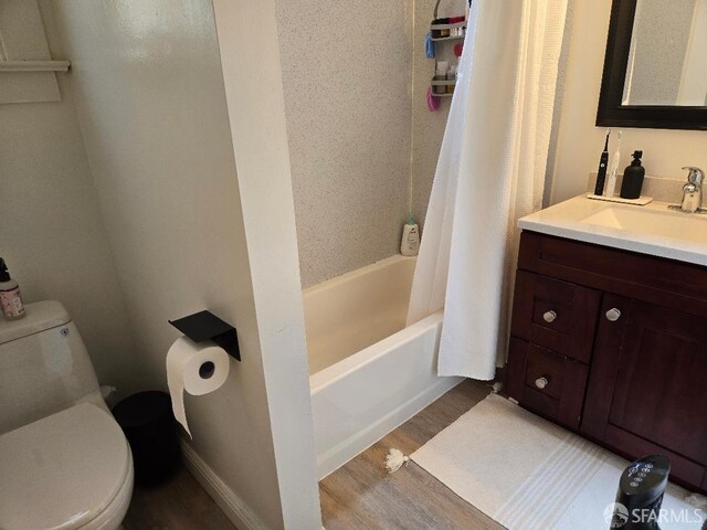 full bath with vanity, shower / bath combo with shower curtain, toilet, and wood finished floors