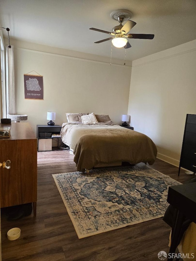 bedroom featuring a ceiling fan, baseboards, and dark wood-style floors