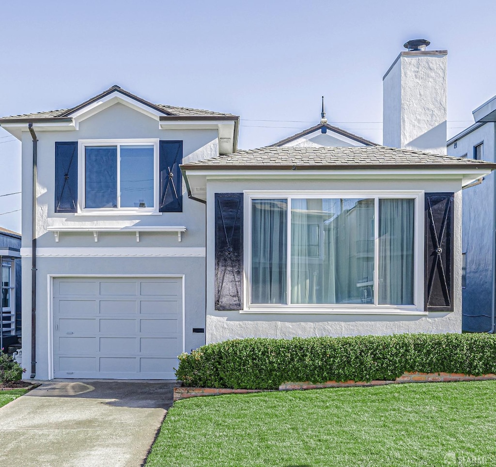 view of front of property with a front lawn and a garage