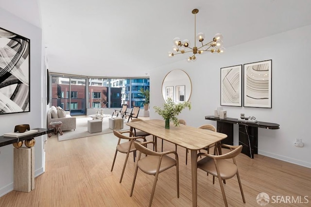 dining room featuring light hardwood / wood-style flooring and a chandelier