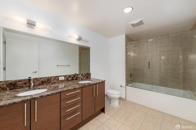 full bathroom featuring tile patterned flooring, vanity, combined bath / shower with glass door, and toilet