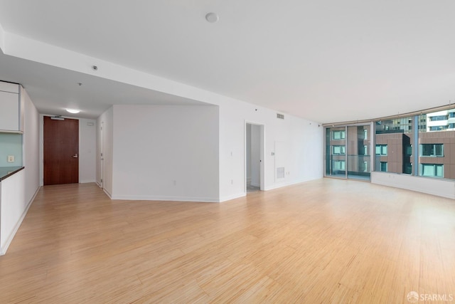 unfurnished living room featuring light wood-type flooring