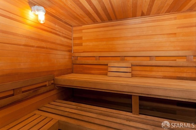 view of sauna / steam room featuring wood walls and wood ceiling