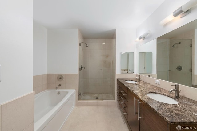 bathroom featuring tile patterned flooring, vanity, and plus walk in shower