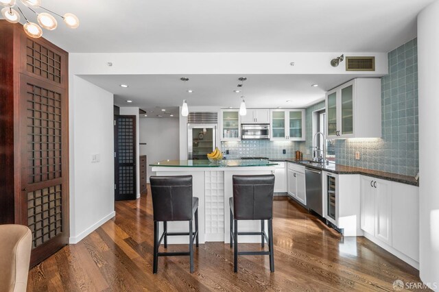333 1st St Unit N1404, San Francisco, CA 94105 - kitchen featuring appliances with stainless steel finishes, a sink, glass insert cabinets, white cabinets, and recessed lighting