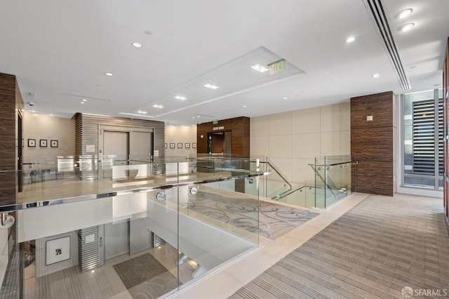 333 1st St Unit N1404, San Francisco, CA 94105 - building lobby featuring tile walls and recessed lighting