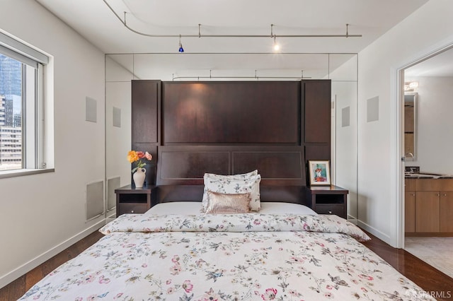 333 1st St Unit N1404, San Francisco, CA 94105 - bedroom with wood finished floors, baseboards, and ensuite bathroom