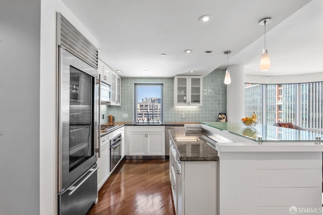 333 1st St Unit N1404, San Francisco, CA 94105 - kitchen featuring stainless steel appliances, backsplash, a center island, white cabinetry, and glass insert cabinets