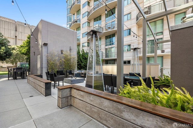 333 1st St Unit N1404, San Francisco, CA 94105 - view of property's community with an outdoor living space with a fire pit, a patio area, and outdoor dining area