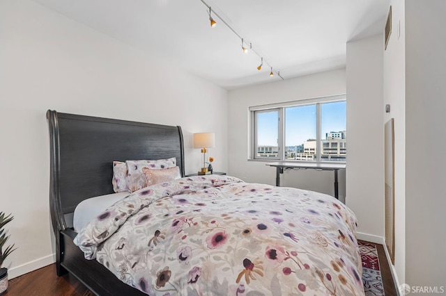 333 1st St Unit N1404, San Francisco, CA 94105 - bedroom featuring baseboards, dark wood-style floors, and rail lighting