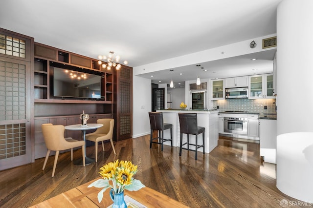 333 1st St Unit N1404, San Francisco, CA 94105 - kitchen with stainless steel appliances, dark wood-style floors, white cabinetry, a kitchen island, and glass insert cabinets