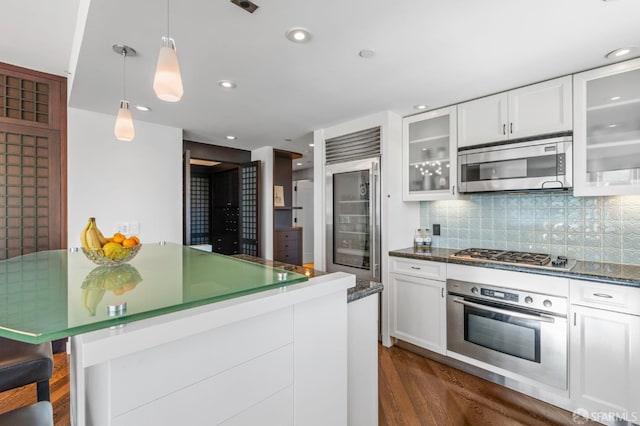 333 1st St Unit N1404, San Francisco, CA 94105 - kitchen featuring stainless steel appliances, white cabinetry, backsplash, glass insert cabinets, and hanging light fixtures