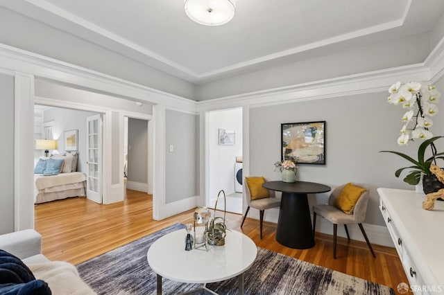 1250 Vallejo St Unit 2, San Francisco, CA 94109 - living room with light wood-style floors, washer / dryer, french doors, and a tray ceiling