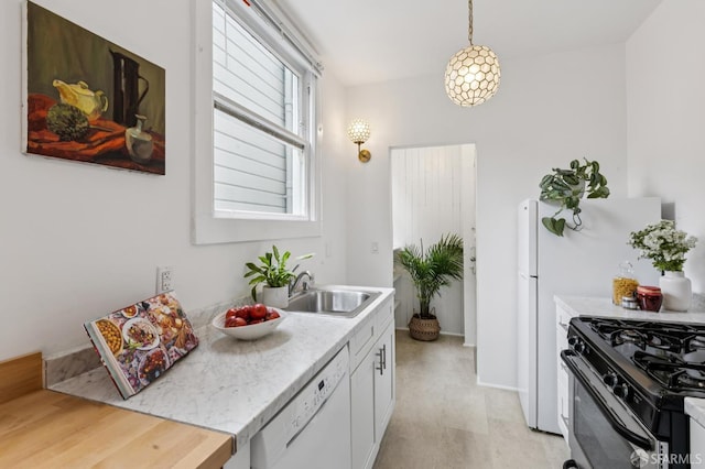 1250 Vallejo St Unit 2, San Francisco, CA 94109 - kitchen with white dishwasher, light countertops, stainless steel gas stove, hanging light fixtures, and white cabinets