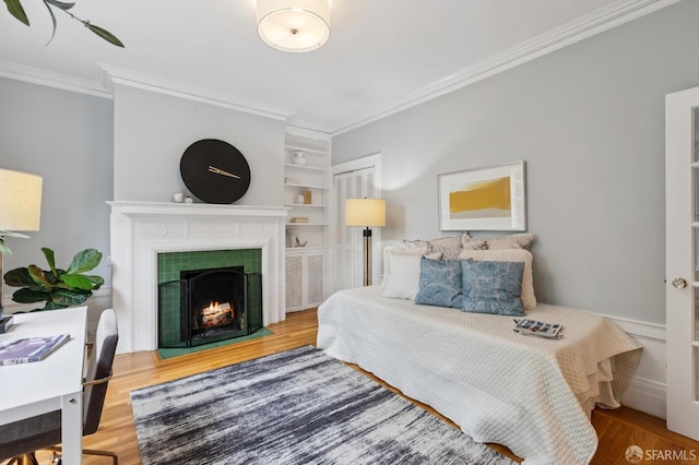 1250 Vallejo St Unit 2, San Francisco, CA 94109 - bedroom featuring ornamental molding, wood finished floors, and a fireplace
