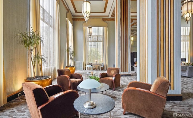 living area featuring crown molding and carpet flooring