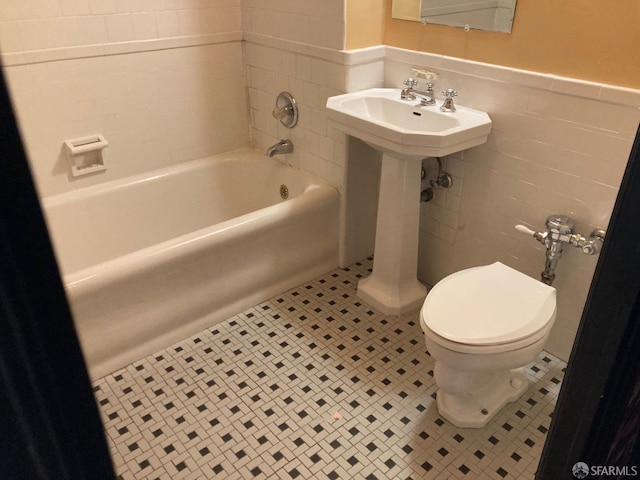 bathroom featuring tile walls, toilet, and tile patterned floors