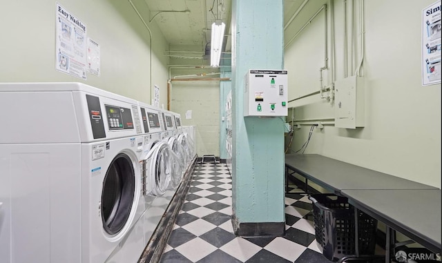 shared laundry area with tile patterned floors and independent washer and dryer