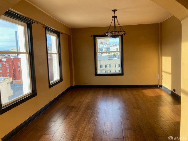 unfurnished dining area with dark hardwood / wood-style flooring