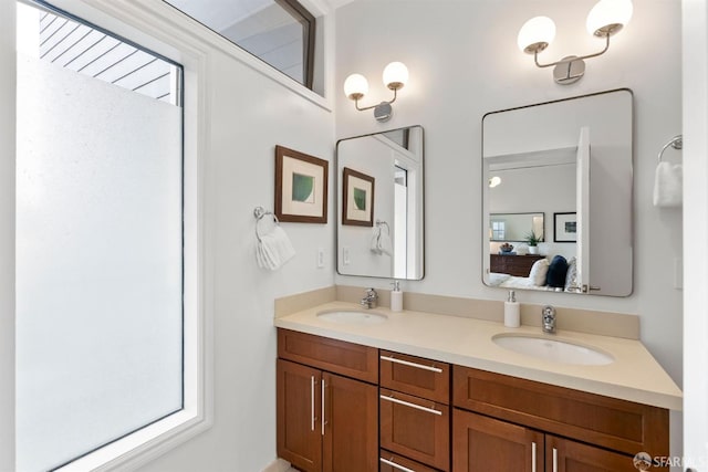 full bathroom featuring a sink, ensuite bath, and double vanity