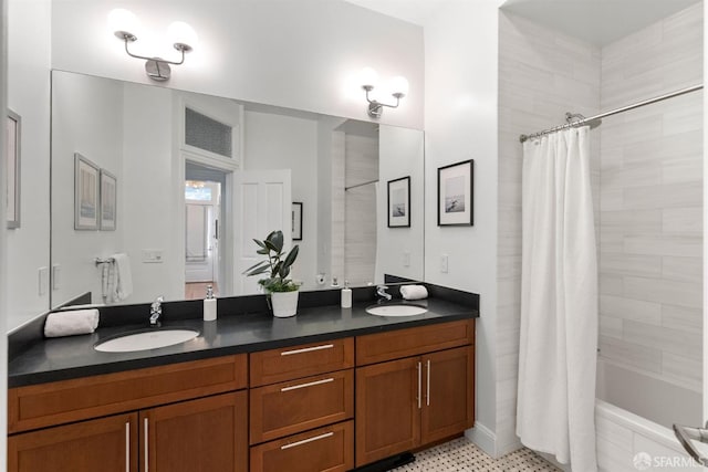 bathroom featuring a sink, tiled shower / bath combo, and double vanity