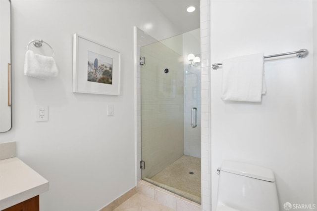 bathroom with toilet, a stall shower, tile patterned flooring, and vanity