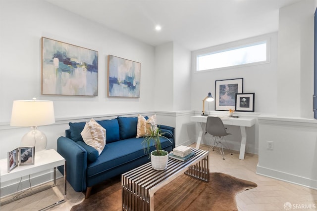 living area featuring baseboards and recessed lighting