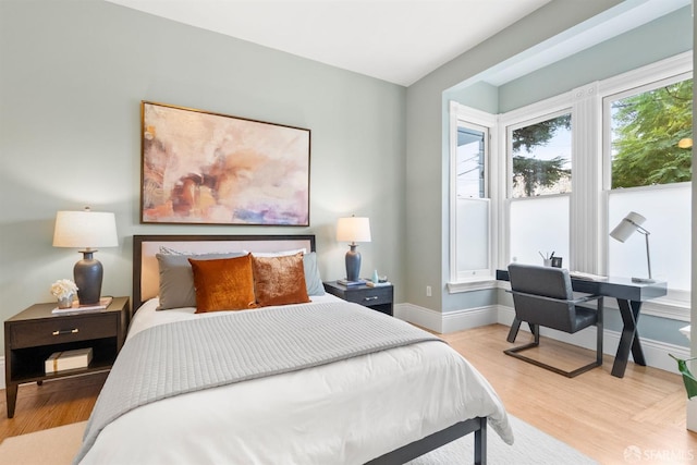 bedroom featuring light wood-type flooring and baseboards