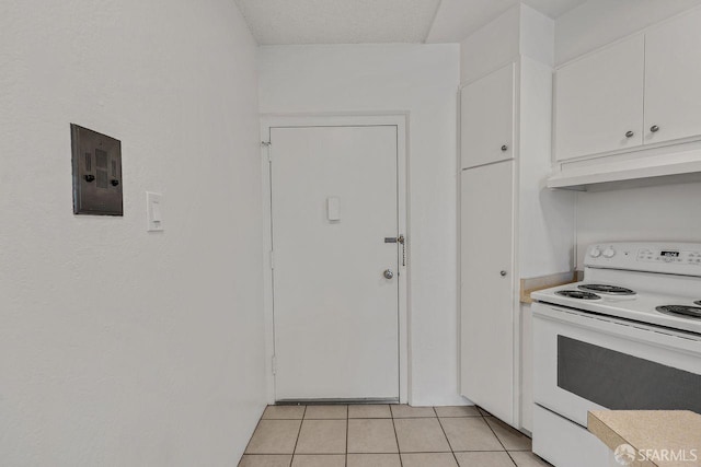 1200 Gough St Unit 4B, San Francisco, CA 94109 - kitchen featuring electric range, custom range hood, white cabinetry, light tile patterned floors, and light countertops