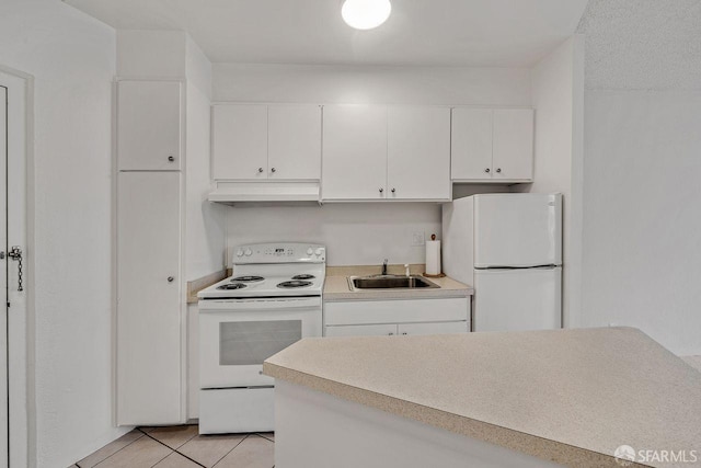 1200 Gough St Unit 4B, San Francisco, CA 94109 - kitchen featuring white appliances, under cabinet range hood, white cabinets, light tile patterned floors, and light countertops