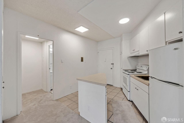 1200 Gough St Unit 4B, San Francisco, CA 94109 - kitchen featuring white appliances, white cabinetry, a center island, and light countertops