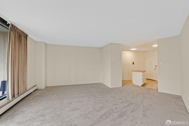 1200 Gough St Unit 4B, San Francisco, CA 94109 - unfurnished living room featuring a baseboard heating unit, light carpet, and a textured ceiling