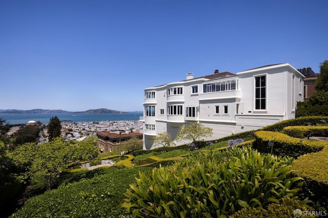 rear view of property featuring a water and mountain view