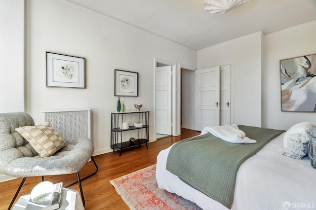 bedroom featuring wood finished floors and baseboards