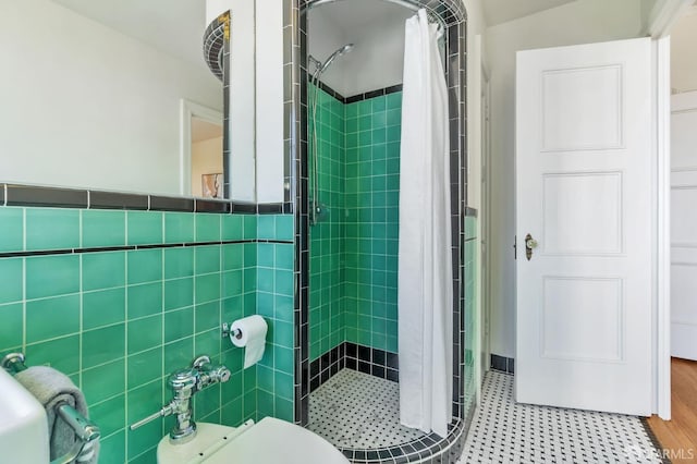 full bath with a shower stall and tile walls