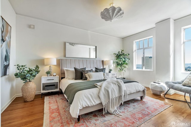 bedroom featuring baseboards and wood finished floors