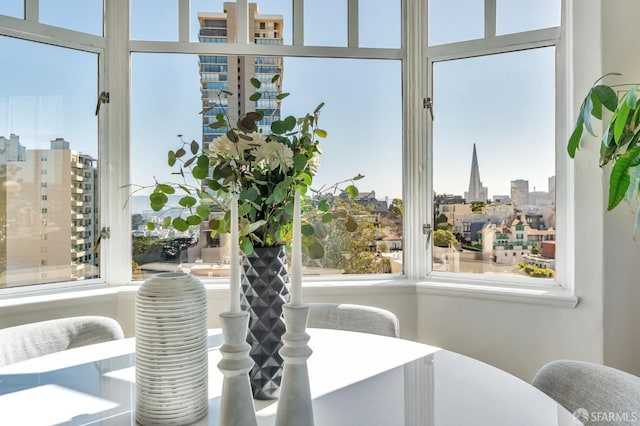 dining room with a view of city and a healthy amount of sunlight