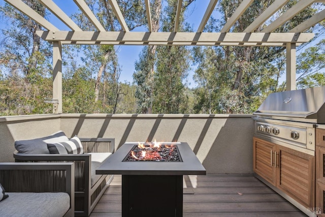 deck with an outdoor fire pit and area for grilling