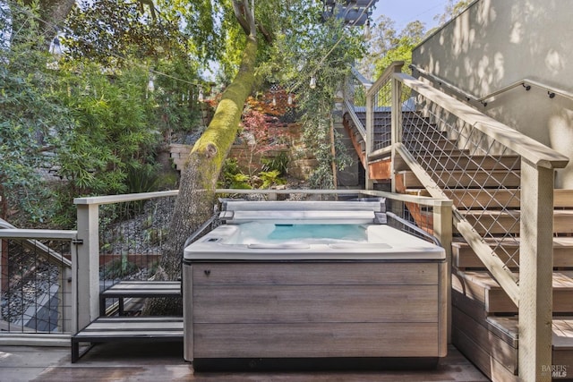 wooden deck with a hot tub