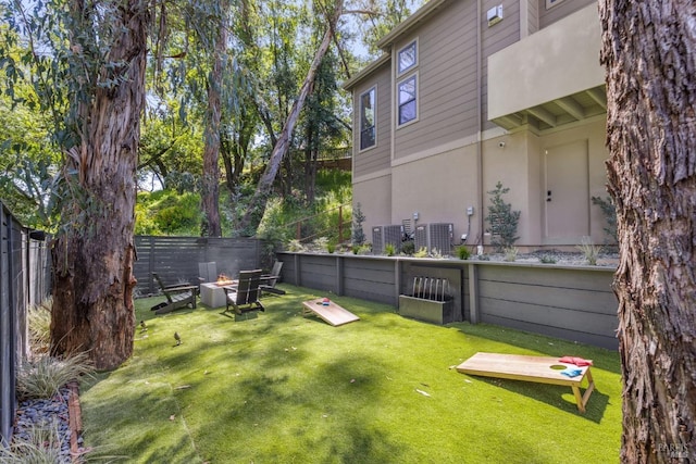 view of yard with a fenced backyard and a fire pit